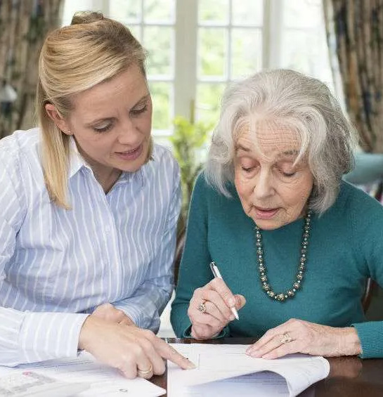 daughter helping mother with paperwork